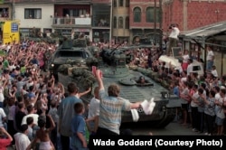 German NATO troops receive a hero's welcome from Kosovar Albanians in the southern city of Prizen in June 1999.