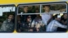 Gay-rights activists look out from a bus as they are evacuated by police during clashes in Tbilisi on May 17.