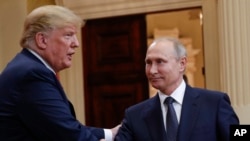 U.S. President Donald Trump and Russian President Vladimir Putin shake hands following a joint news conference at the Presidential Palace in Helsinki in 2018.