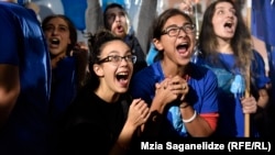 Georgian Dream supporters celebrate their party's strong showing in parliamentary elections in Tbilisi on October 8.