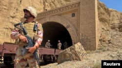 Pakistani soldiers stand at a tunnel where a train was attacked by separatist militants in Balochistan on March 15. Pakistan's border regions near Afghanistan have seen an uptick in insurgent violence in recent years. 