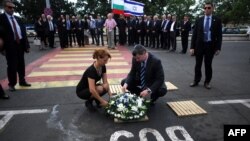  Israel's Tourism Minister Stas Misezhnikov (center right) pays his respects to the five Israeli victims of a suicide blast which targeted a bus of Israeli tourists at Burgas Airport in Bulgaria. 