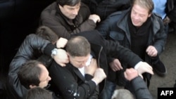 Tbilisi Mayor Gigi Ugulava (center) scuffles with protesters in Tbilisi.