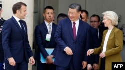 French President Emmanuel Macron (left), Chinese leader Xi Jinping (center), and European Commission President Ursula von der Leyen (right) leave after holding a trilateral talks in Paris in 2024. 